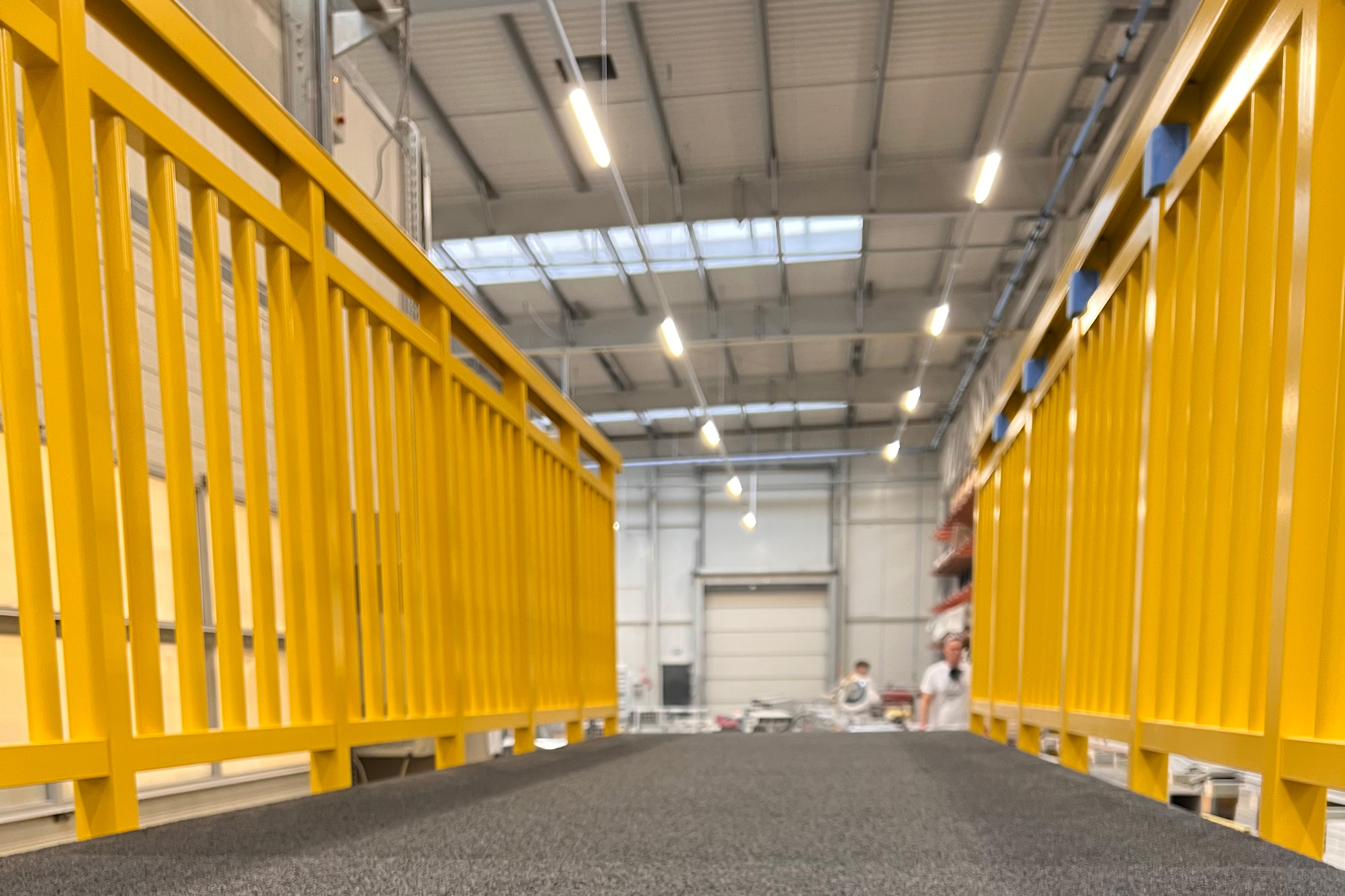 Yellow GRP square tube used as a baluster in a Fiberline handrail system