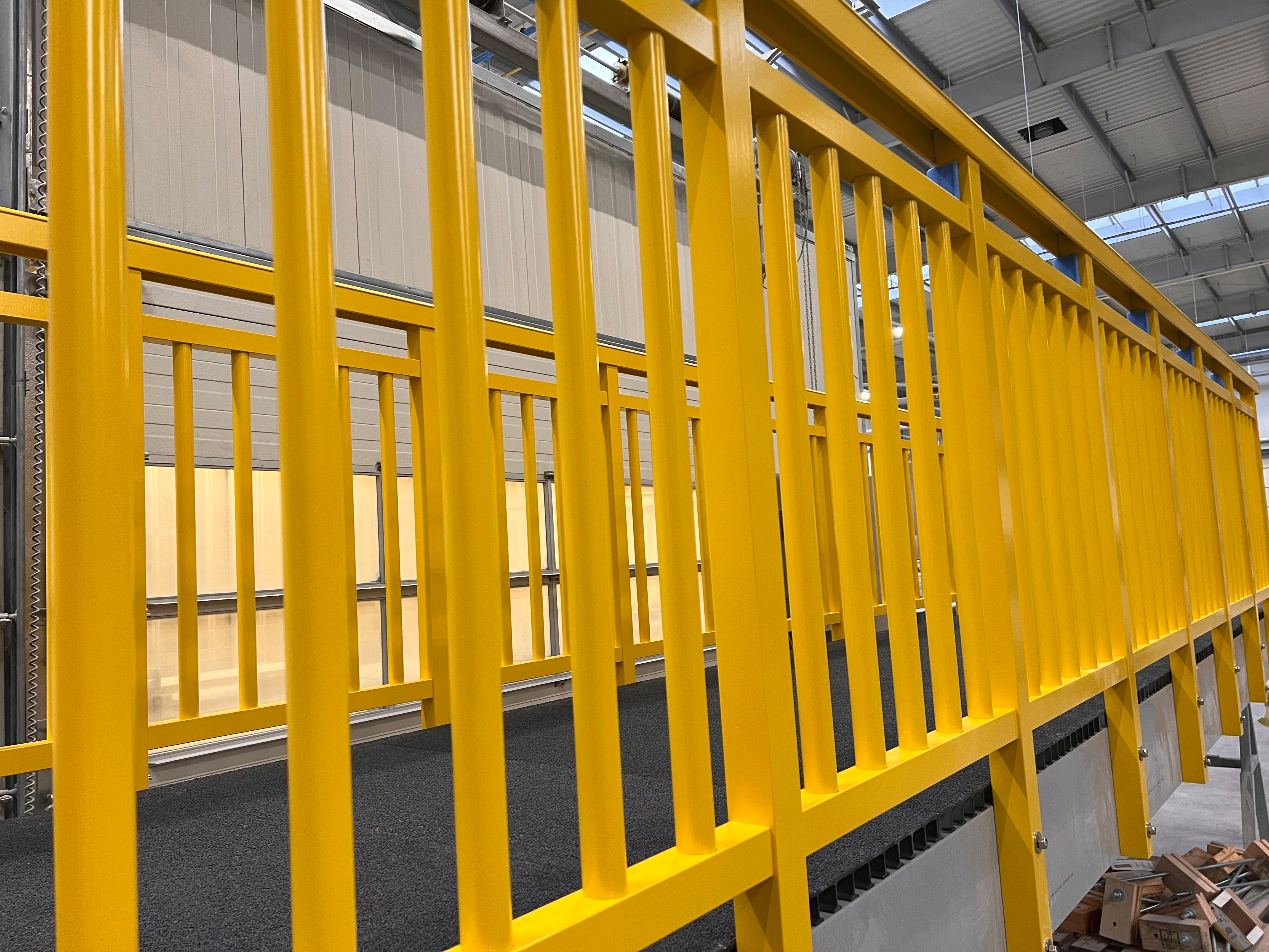 Yellow GRP square tube used as a baluster in a Fiberline handrail system