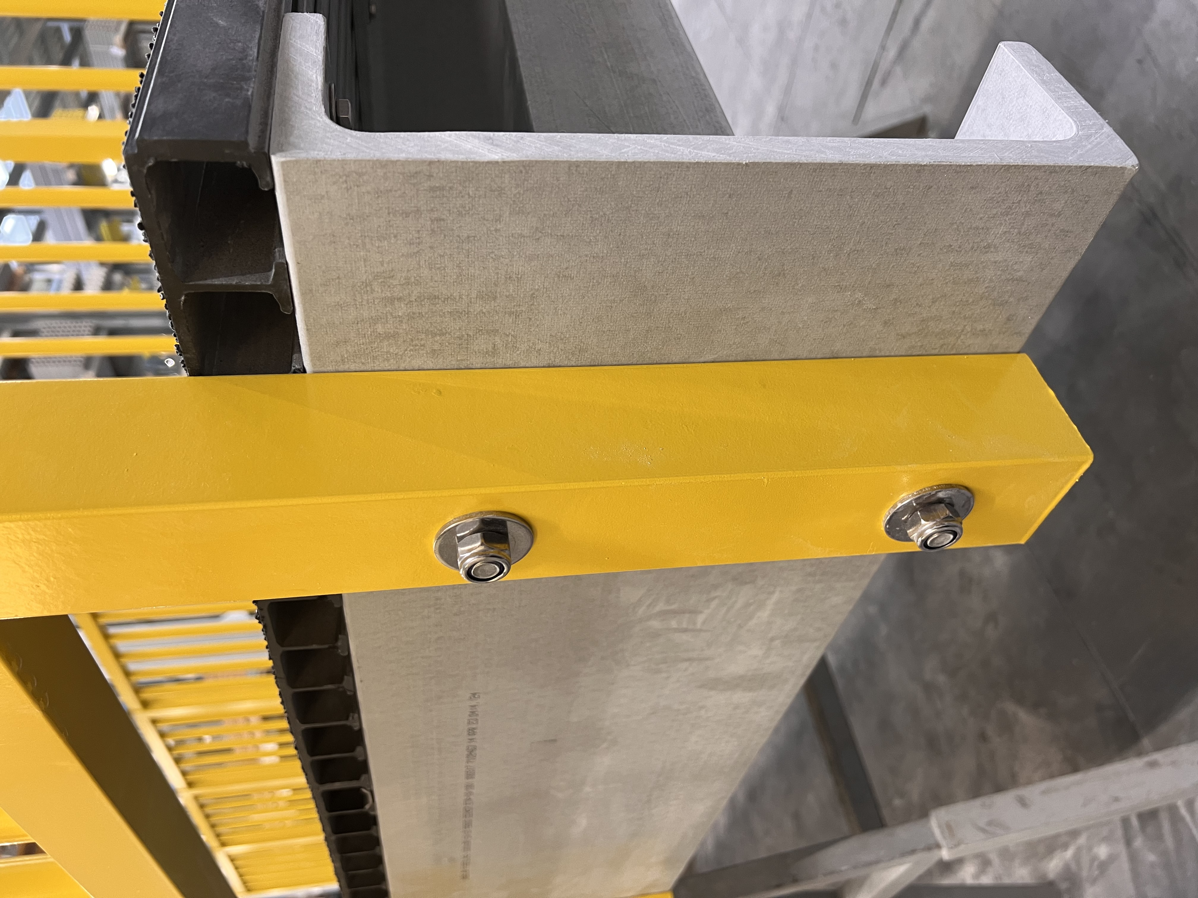 Yellow GRP square tube used as a baluster in a Fiberline handrail system